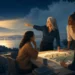 Women leaders guiding a map beside a lighthouse at dusk